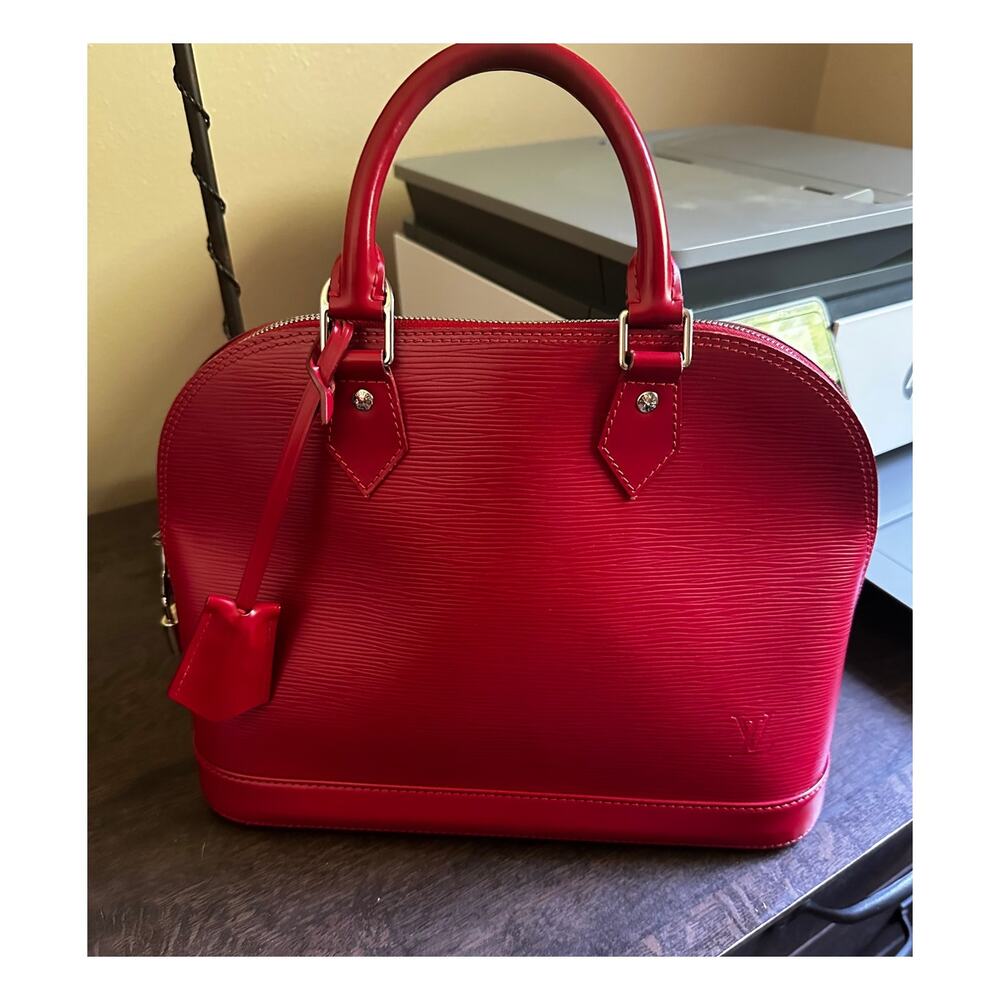 LOUIS VUITTON FUCHSIA RED ALMA WITH SILVER HARDWARE;  LOCK & KEYS AND CLOCHETTE